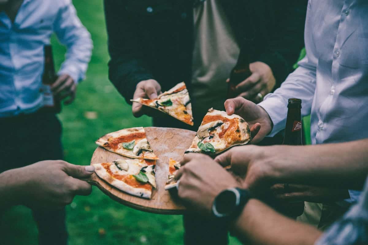 Guests gathered around the van at a wedding